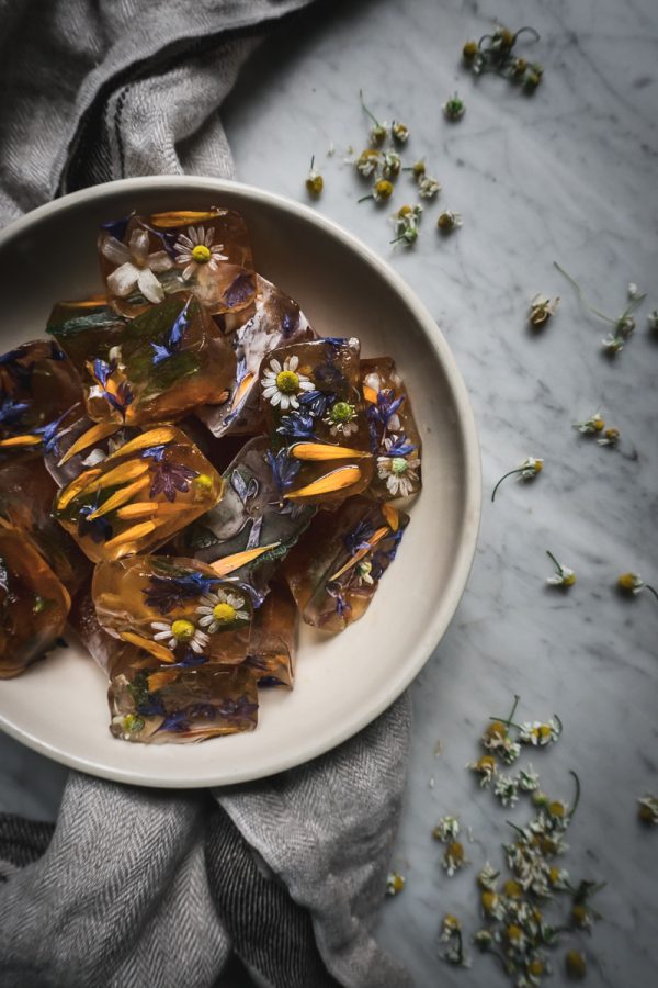 bowl filled with ice cubes made from edible flowers